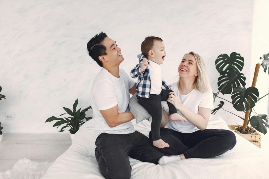A joyful family spending quality time together indoors, enjoying laughter and togetherness.